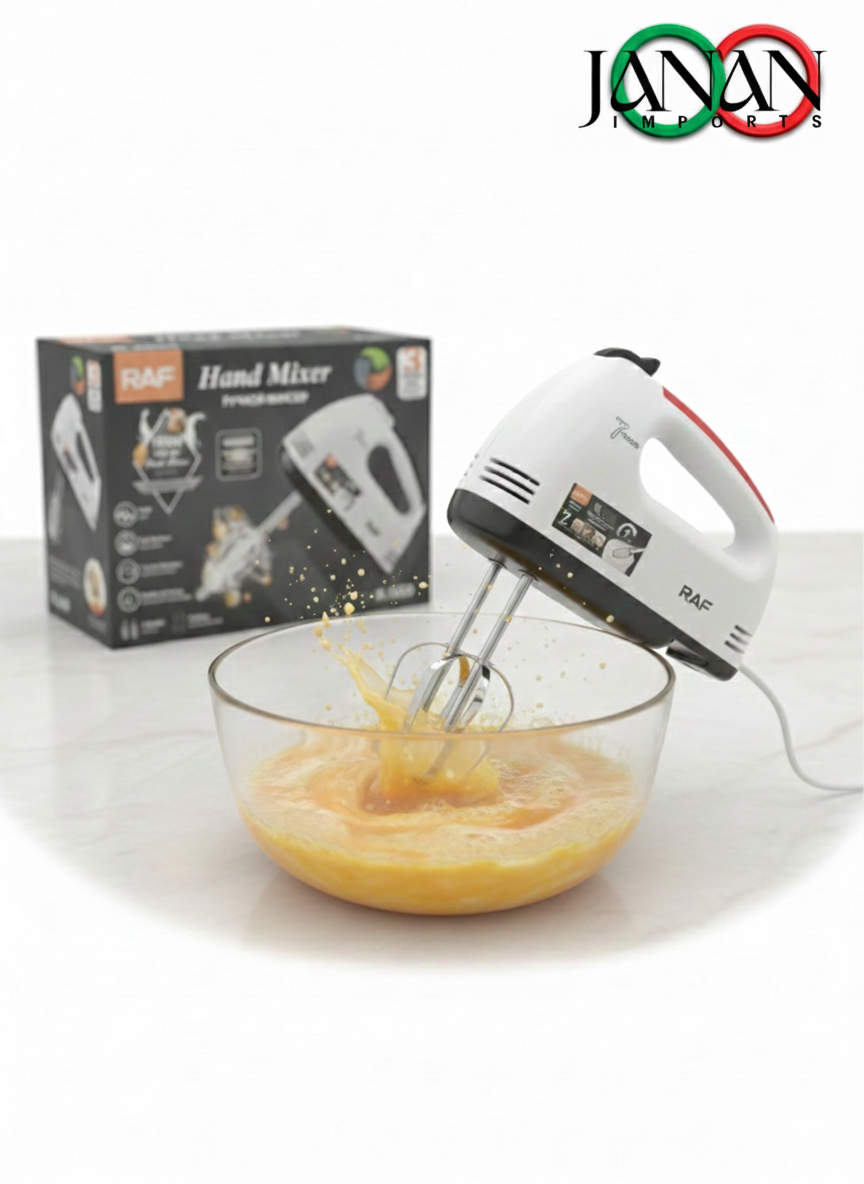 Hand mixer in use with a bowl of yellow mixture, next to its packaging, on a white background.